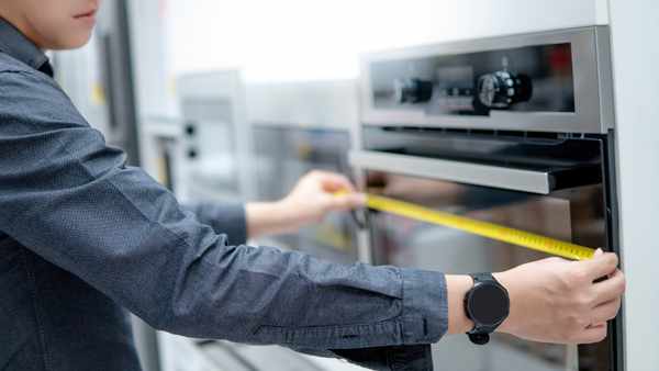 iStock Credit: Zephyr18 Measuring a wall oven